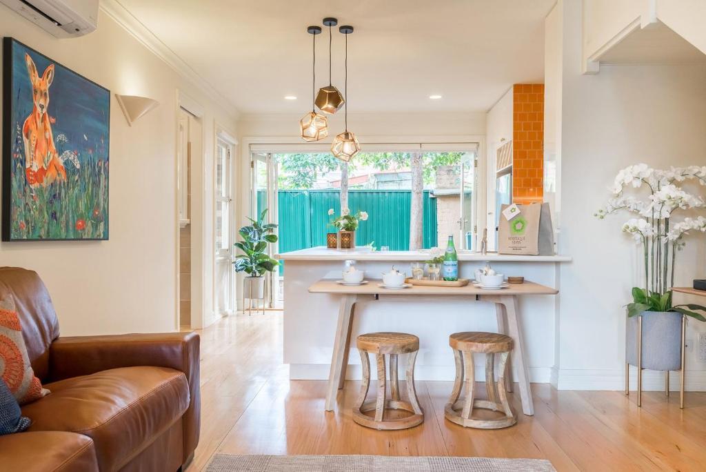 a kitchen with a table and stools in a room at Boutique Stays - Buckingham in Melbourne