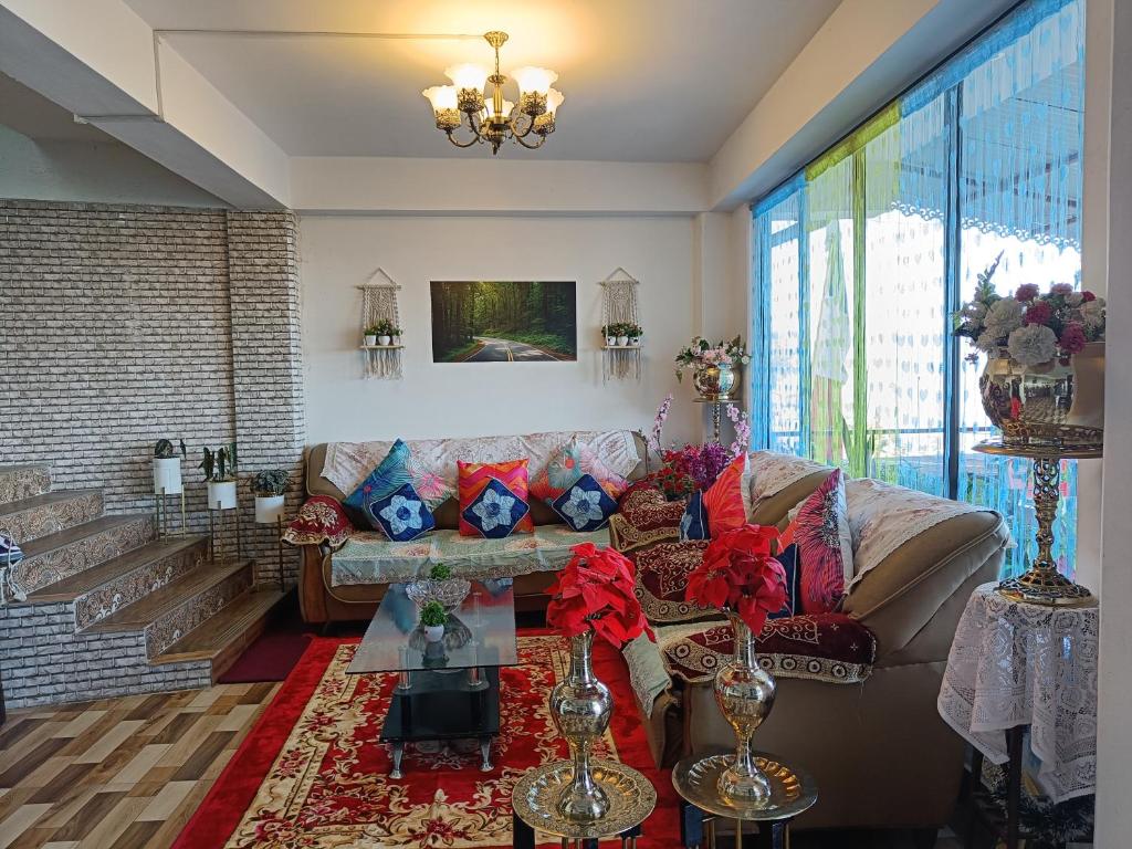 a living room with a couch and a table at Wonder Hill Parivaar homestay in Darjeeling