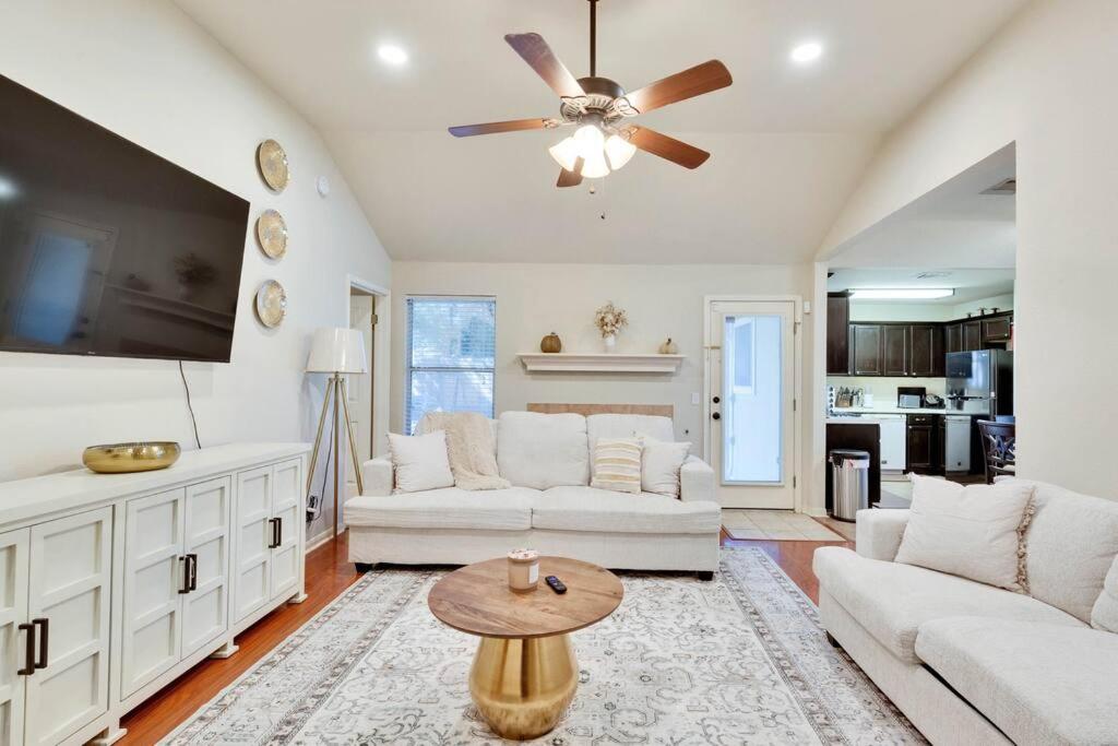 a living room with white furniture and a ceiling fan at Charming and Comfort 3BR/2BA Retreat in Kyle in Kyle