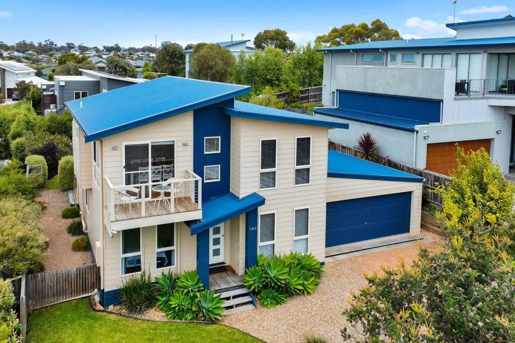 an aerial view of a house with a blue roof at Twin Beaches Retreat Cowes in Cowes