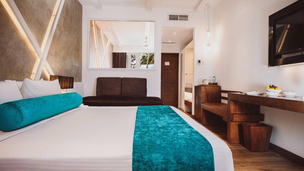Postel nebo postele na pokoji v ubytování Camelot Beach Hotel