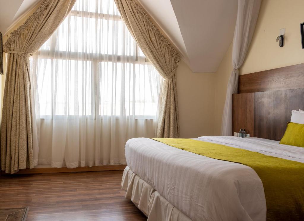 Postel nebo postele na pokoji v ubytování D2W Residency Suites
