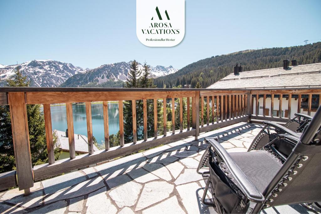 a balcony with a view of a lake and mountains at Sans Souci EG in Arosa