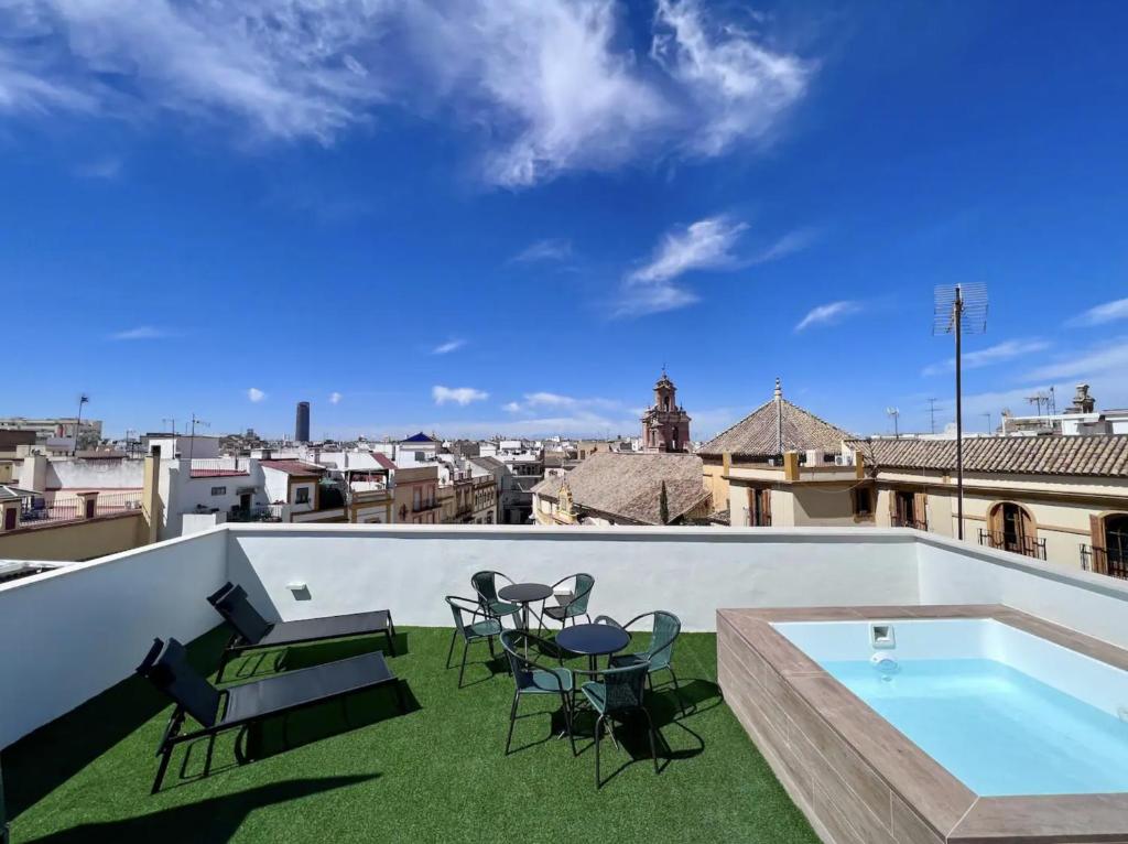 a patio with chairs and a swimming pool on a roof at LEYENDA DEL HEREJE in Seville