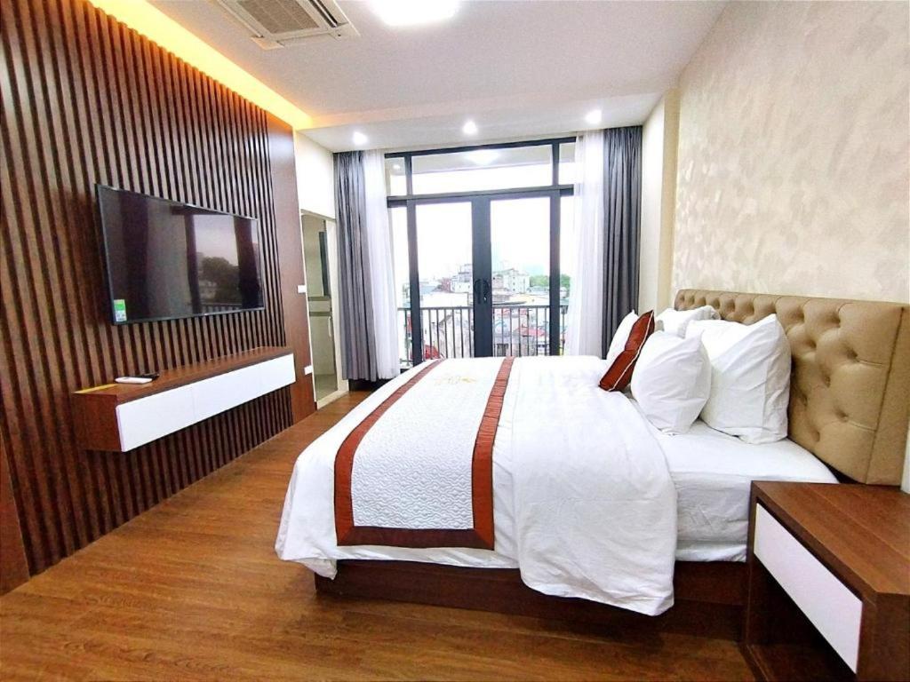 a hotel room with a bed and a television at Hanvet Hotel HN - by BAY LUXURY in Hanoi