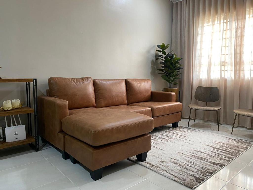 a brown leather couch in a living room at Seaview apartment in Kuala Terengganu