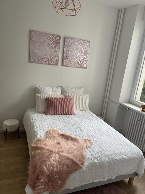 une chambre avec un lit avec une couverture dessus dans l'établissement Appart 3p RDC Orangerie- Parlement européen, à Strasbourg