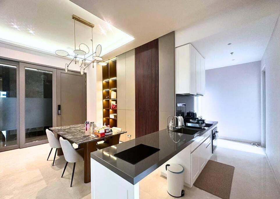 a kitchen with a table and a dining room at NEW Charming 2BR Apartment in Central Jakarta in Jakarta