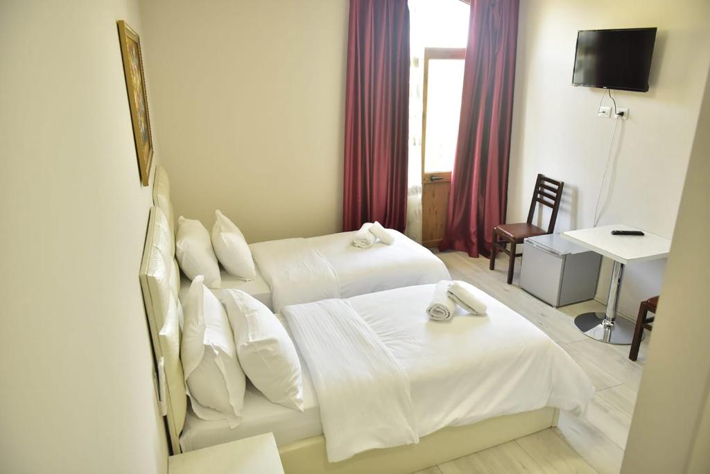 Postel nebo postele na pokoji v ubytování Buna Park Hotel