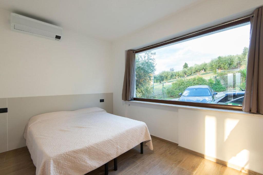 Postel nebo postele na pokoji v ubytování Green Residence Villa Assunta