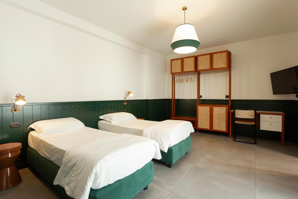 Postel nebo postele na pokoji v ubytování Hotel Ghalà