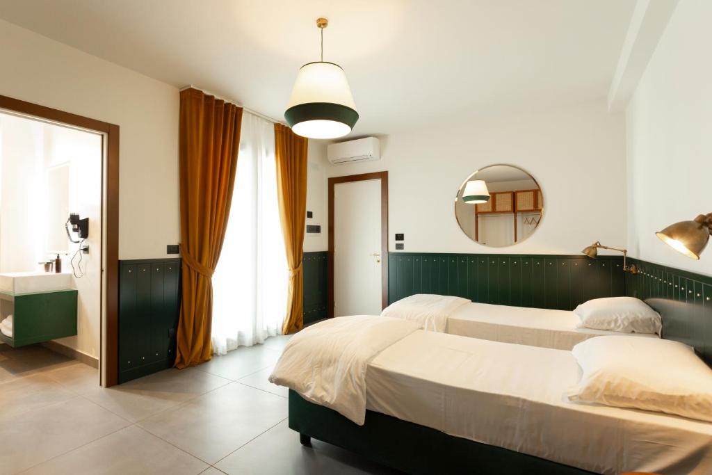 Postel nebo postele na pokoji v ubytování Hotel Ghalà