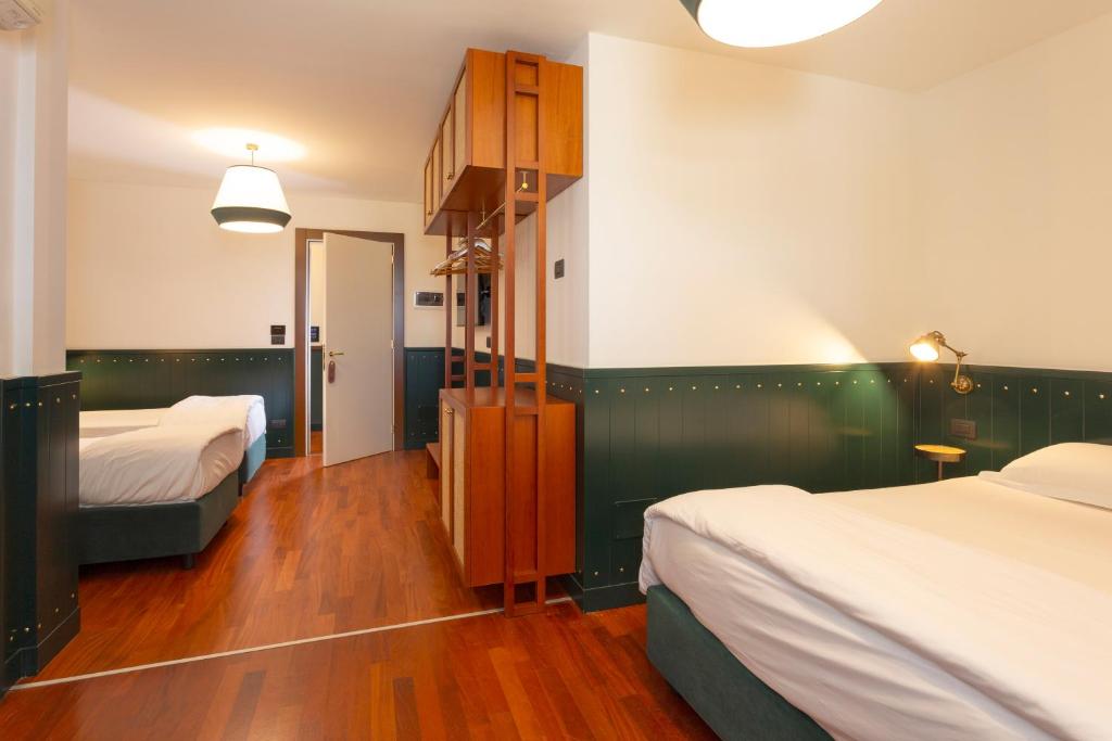 Postel nebo postele na pokoji v ubytování Hotel Ghalà