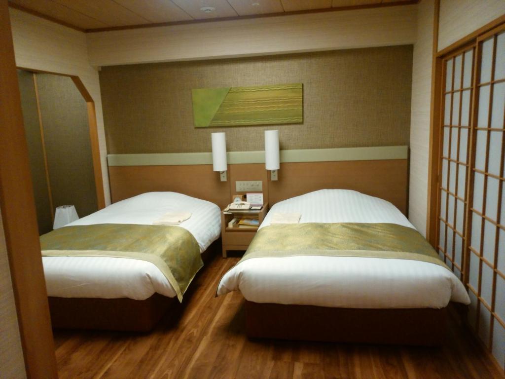 Postel nebo postele na pokoji v ubytování JR Hotel Clement Tokushima