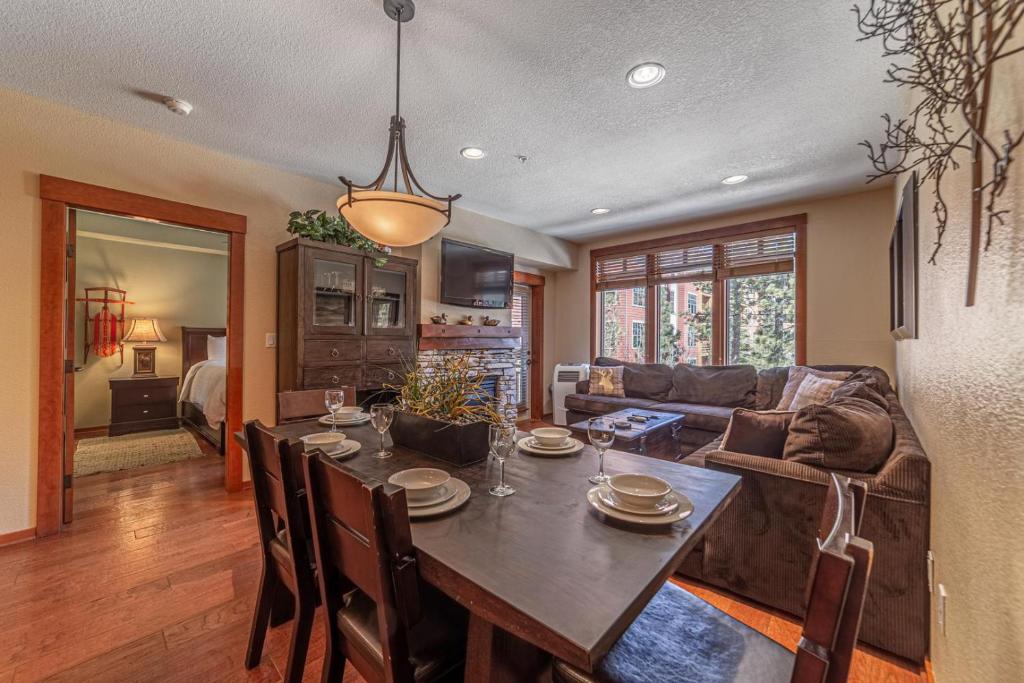 a living room with a table and a couch at 506 Village Condo Steps to Gondola in Mammoth Lakes