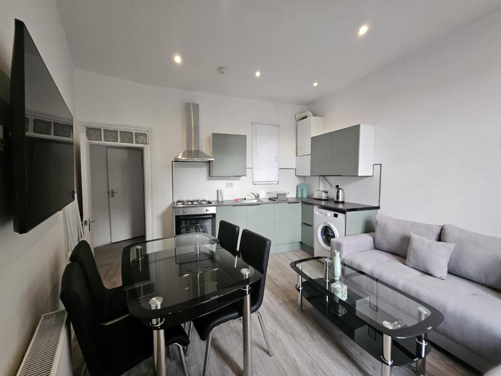 a living room with a couch and a glass table at Battersea Park apartments in London