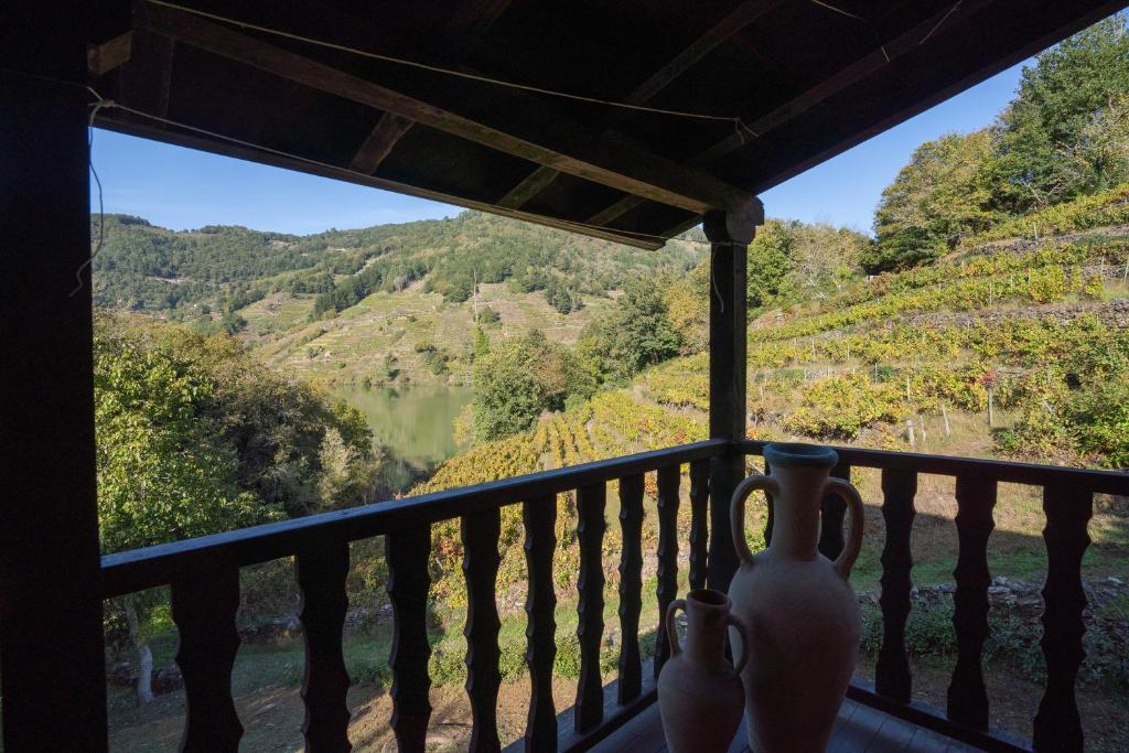 a room with a balcony with a view of a valley at Casa Muíñovedro in Chantada