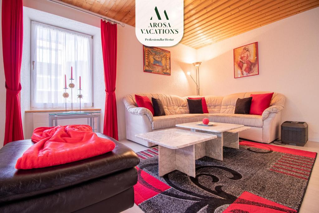a living room with a couch and a table at Haus Padrun, Apartment nr.8 in Arosa
