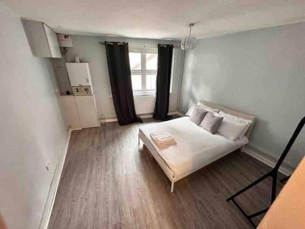 a small room with a bed and a window at London Apartment - Near Kings Cross St Pancreas! in London