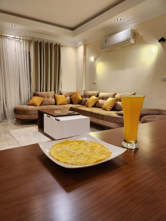 a plate of food on a table in a living room at Wa set Luxor Apartment in Luxor