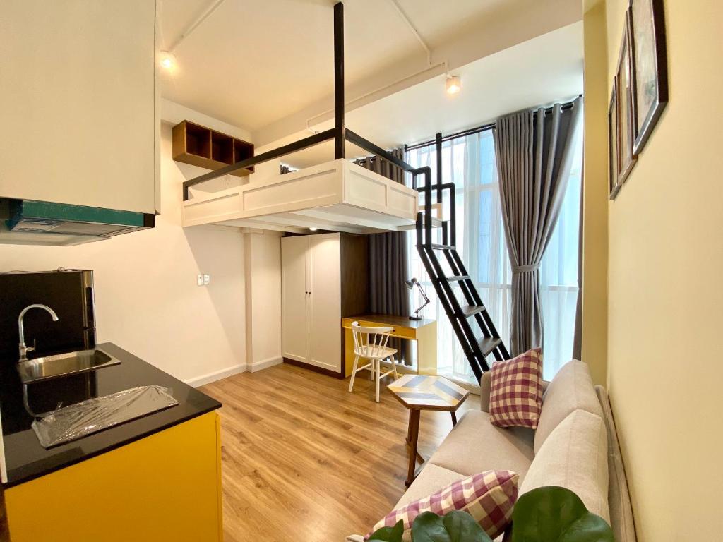 a living room with a couch and a kitchen at 8 minutes walking to Nguyen Hue, Fast Wifi, check-in 24/7 in Ho Chi Minh City
