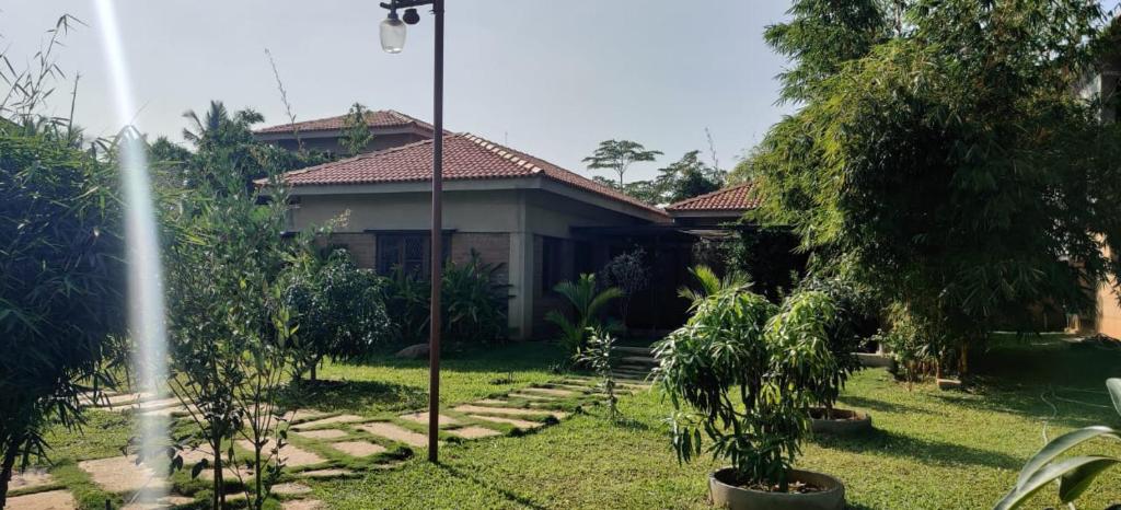 a house with a garden in front of it at Serene meadows villa in Bangalore