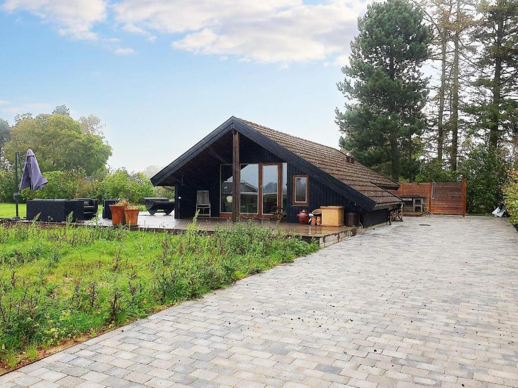 een klein huis met een paviljoen in een veld bij 6 person holiday home in Stubbek bing in Stubbekøbing