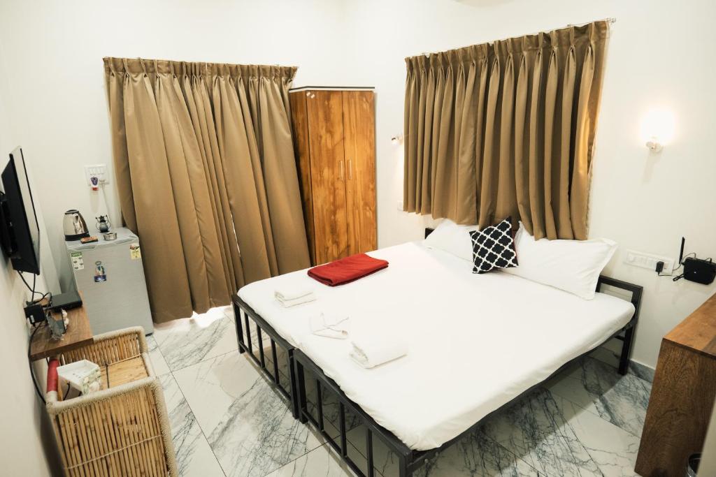 Postel nebo postele na pokoji v ubytování Nirvana Homestays