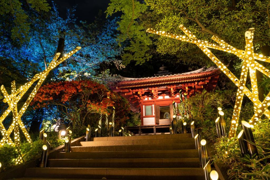 a temple in a garden with christmas lights at Grand Prince Hotel Takanawa in Tokyo