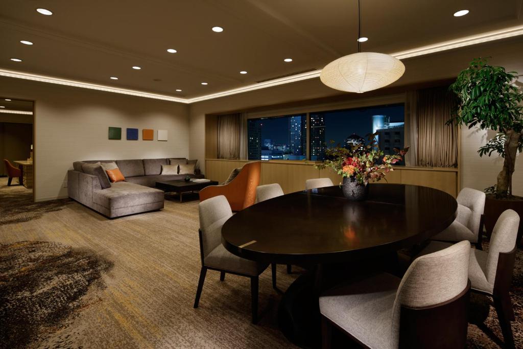a living room with a table and a couch at Grand Prince Hotel Takanawa in Tokyo