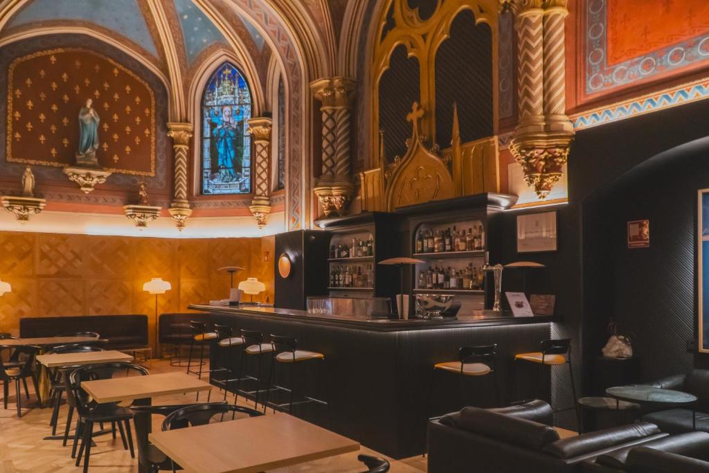 a bar in a restaurant with tables and chairs at Zenit Convento San Martin in San Sebastián
