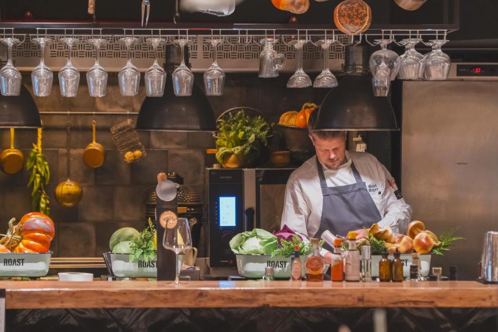 a chef preparing food in a kitchen at Zenit Convento San Martin in San Sebastián