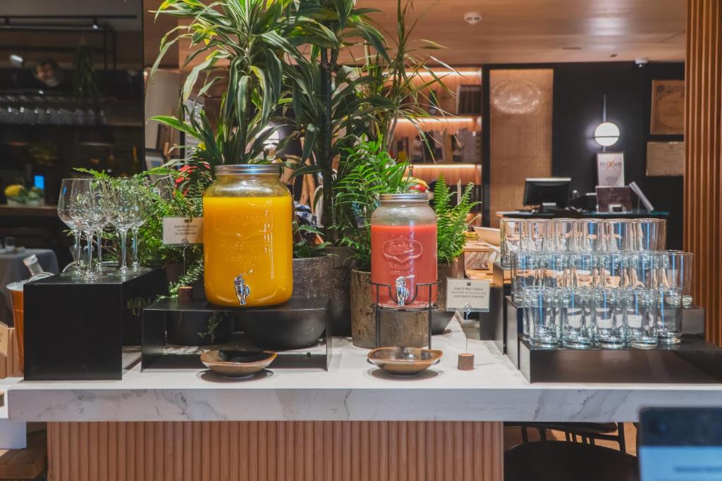 a counter with two jars of drinks and glasses at Zenit Convento San Martin in San Sebastián