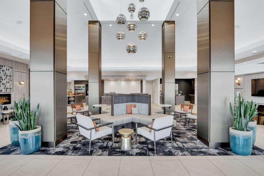 a hotel lobby with a couch and chairs at Hilton Garden Inn Toronto/Brampton in Brampton