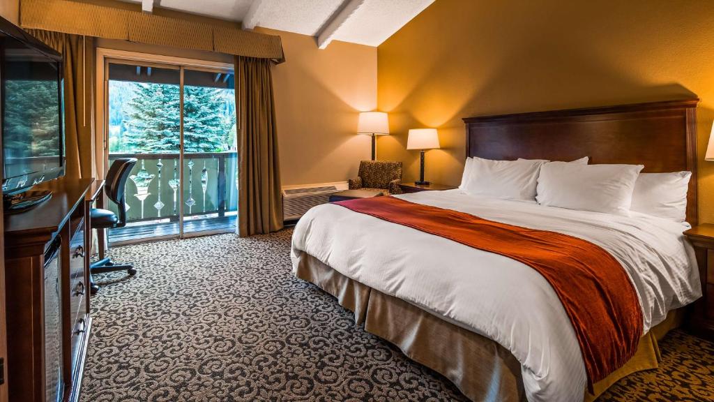 a hotel room with a bed and a large window at Best Western Tyrolean Lodge in Ketchum