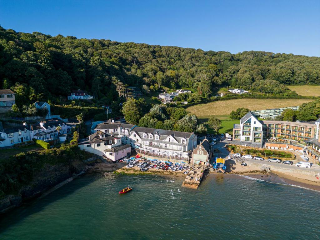 an aerial view of a resort with a beach and buildings at South Sands Hotel in Salcombe
