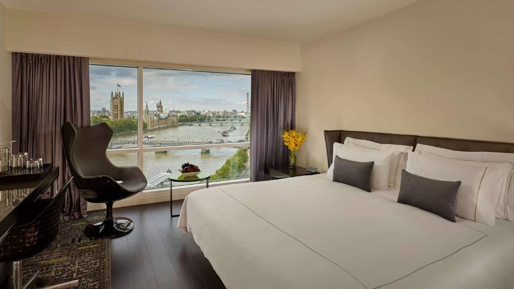 a hotel room with a bed and a large window at Park Plaza London Riverbank in London