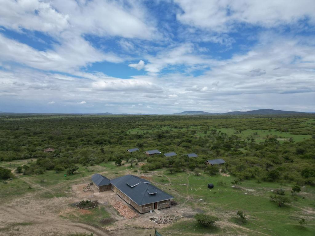 an aerial view of a house in the middle of a field at Resian Mara Camp in Talek