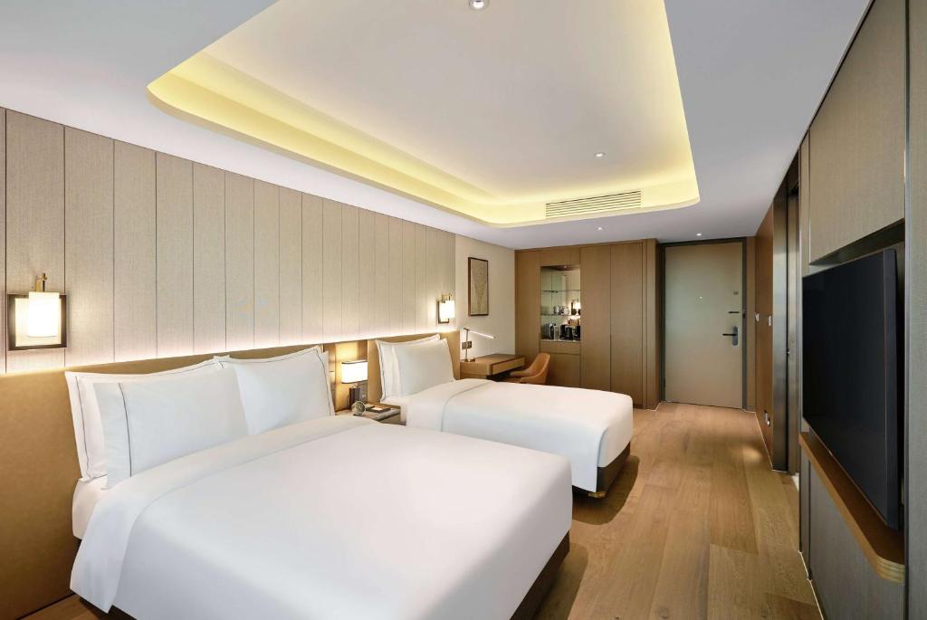 Postel nebo postele na pokoji v ubytování Wyndham Grand Busan