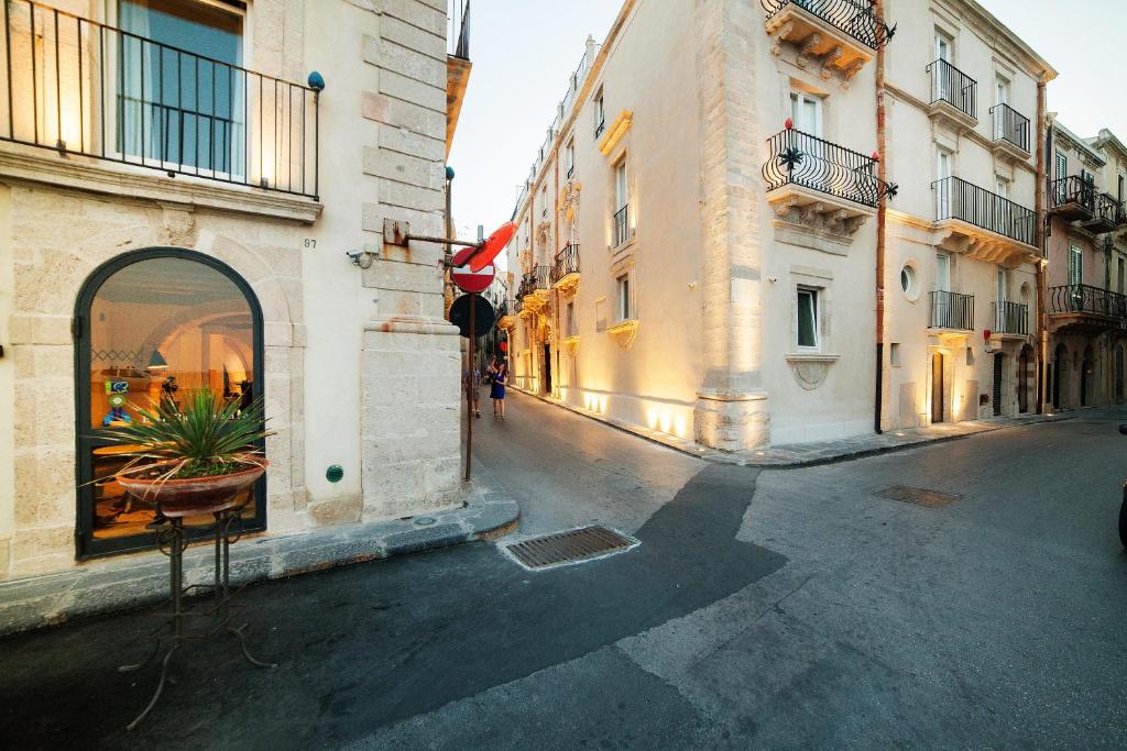 an empty street in a city with buildings at Algilà Ortigia Charme Hotel in Siracusa