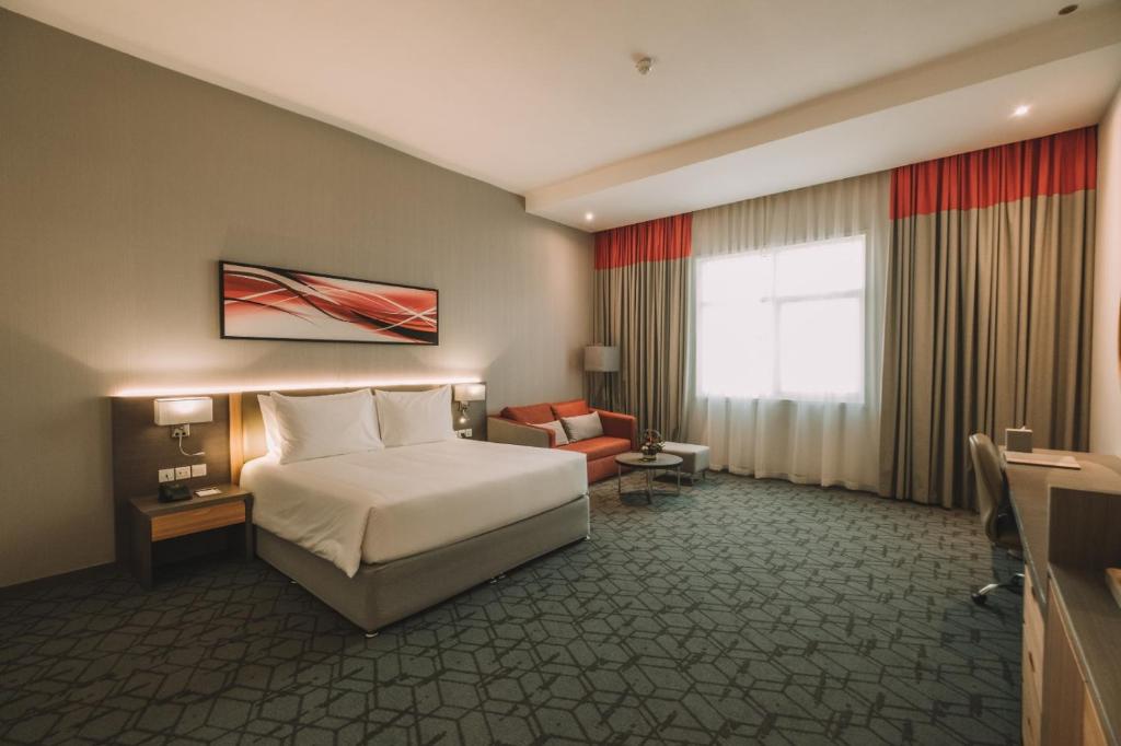 Postel nebo postele na pokoji v ubytování Peony Hotel