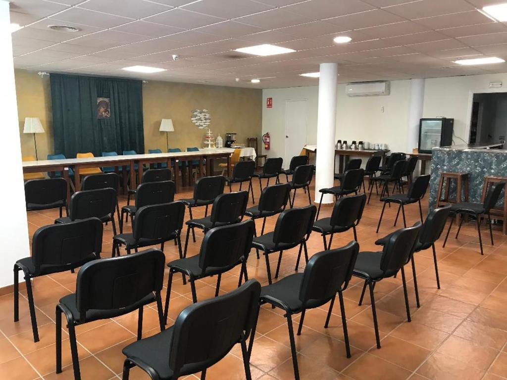 a room full of chairs in a room with a table at Macavi in Rota