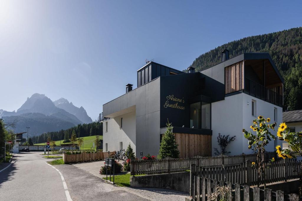 a house in the mountains with a fence at Ariane's Guesthouse in Sesto