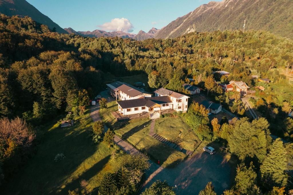 an aerial view of a house in the mountains at Hotel Mi Casa in Chaitén
