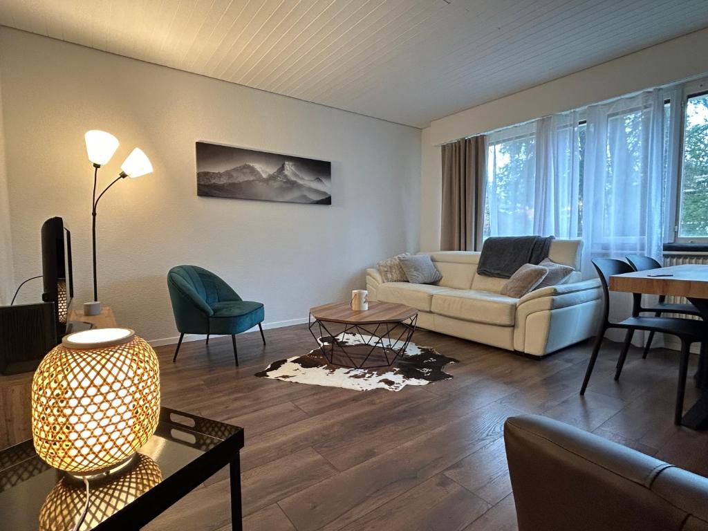 a living room with a couch and a table at Résidence Plambramois in Crans-Montana