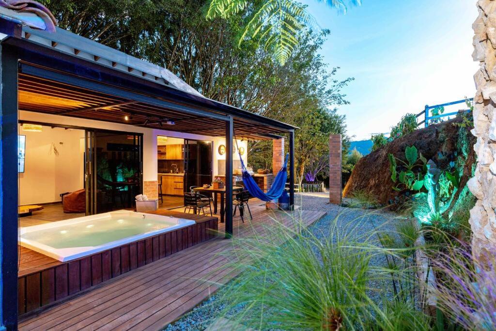 a jacuzzi tub on the deck of a house at Sweet Helen Llanogarden in Rionegro
