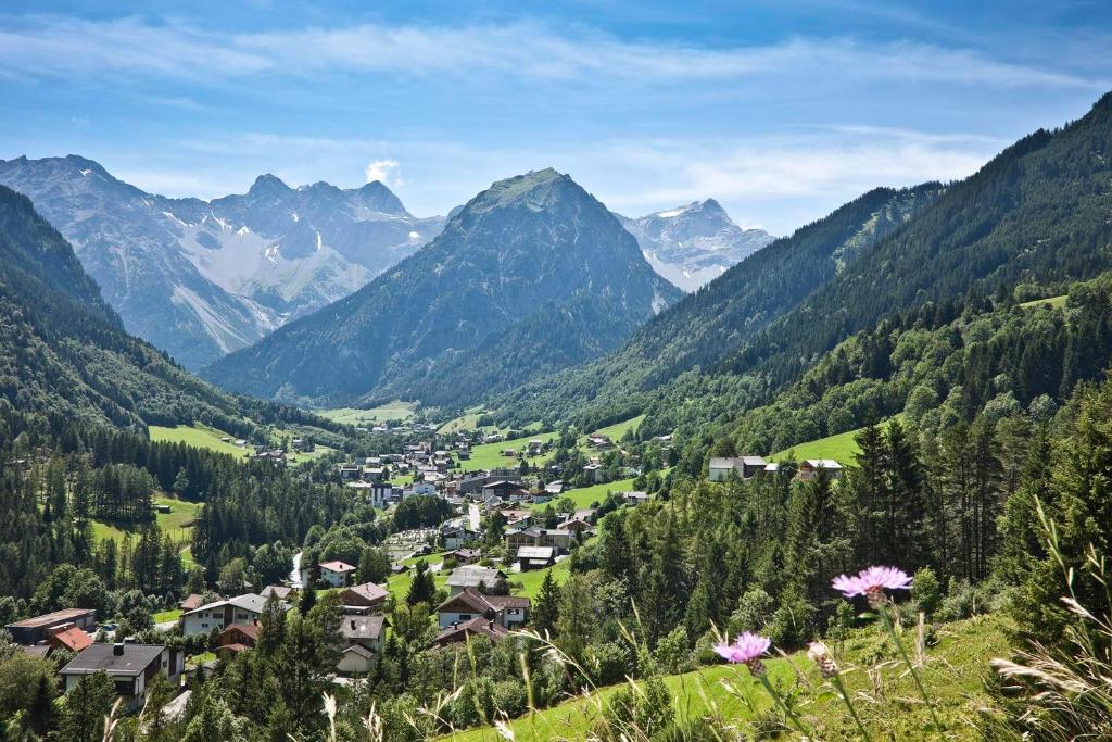 a village in a valley with mountains in the background at Haus Rätikon in Brand