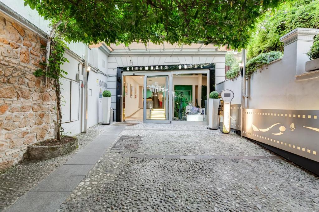 an alleyway leading to a building with a door at Best Western Cinemusic Hotel in Rome