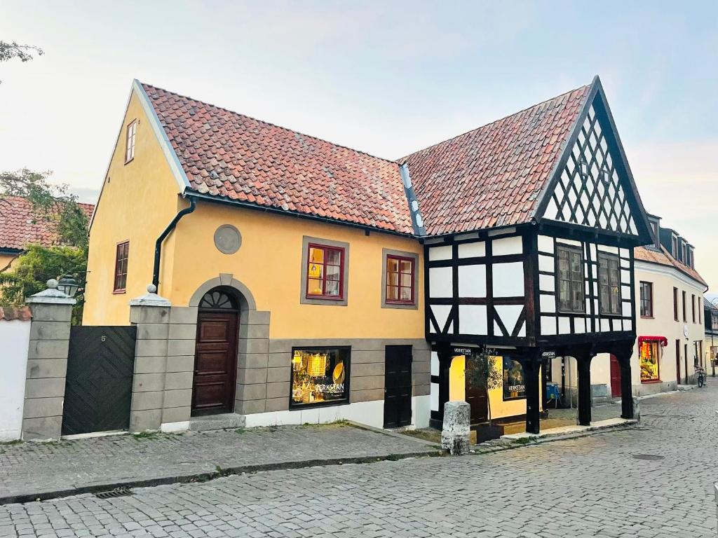 a yellow and black building on a street at Verkstan Hotel in Visby
