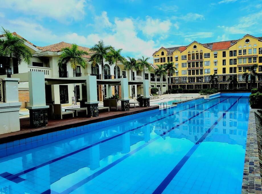 a large swimming pool in front of buildings at Neroki's Crib Cozy & Luxurious Staycation! in Cebu City